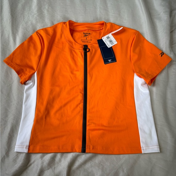 NWT Reebok Athletic Crop Orange & White Short Sleeve Shirt Size Women’s Large - Picture 1 of 3